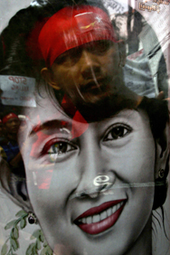 The face of a Myanmar dissident (top) is reflected over the portrait of pro-democracy icon Aung San Suu Kyi during a protest outside the Myanmar embassy in downtown Kuala Lumpur. (AFP/Getty Images)